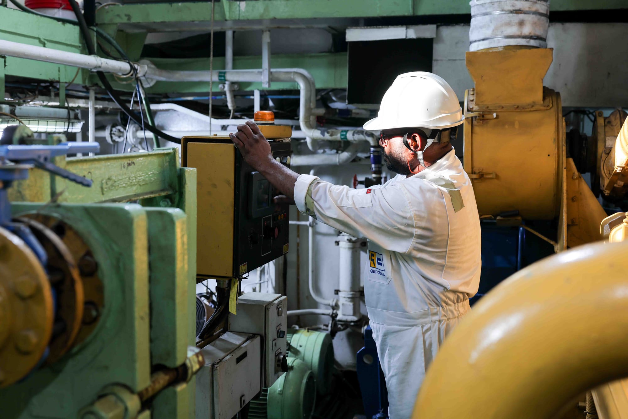 An engineer servicing machinery on board.